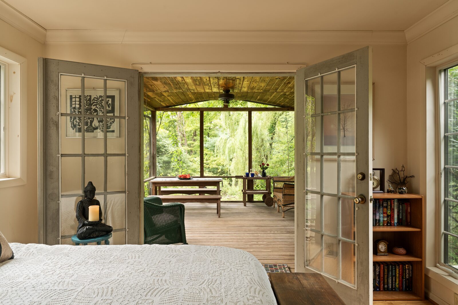 French doors open from the bedroom into the screened three-season room