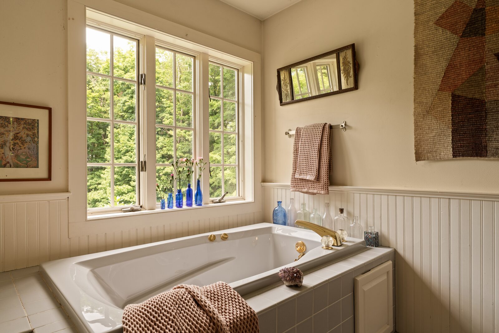 The bath, with a soaking tub set beneath a window