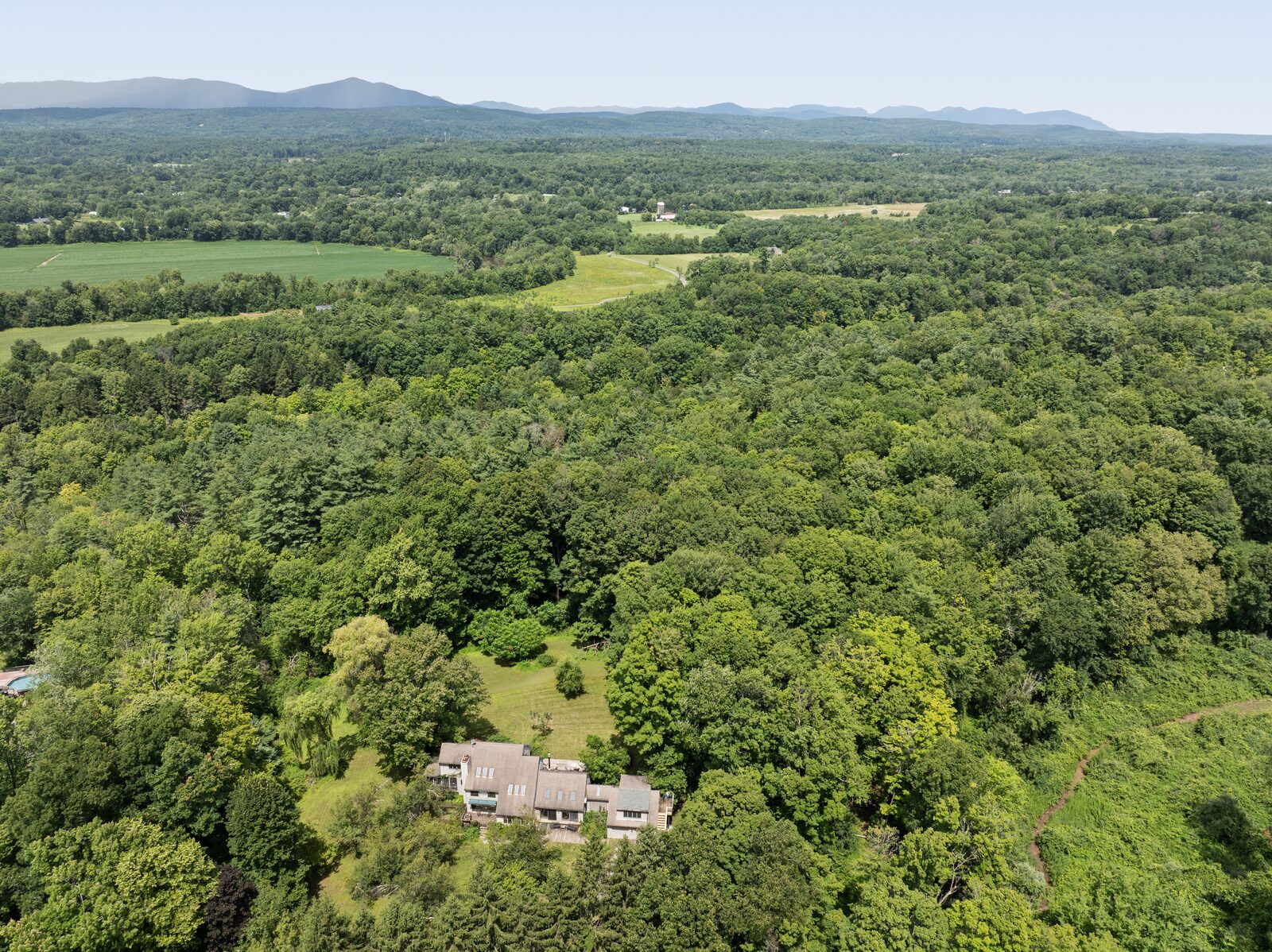 From the air — the valley beyond the treeline, the Shawangunk ridge on the horizon